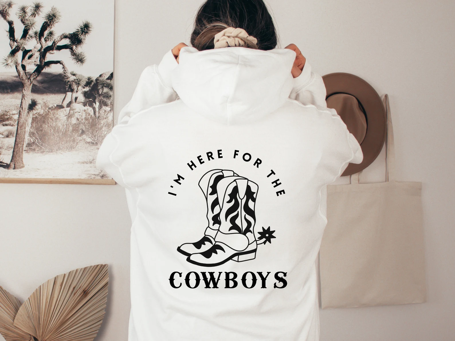 Warm white sweater with cowboy boots illustration on the back.