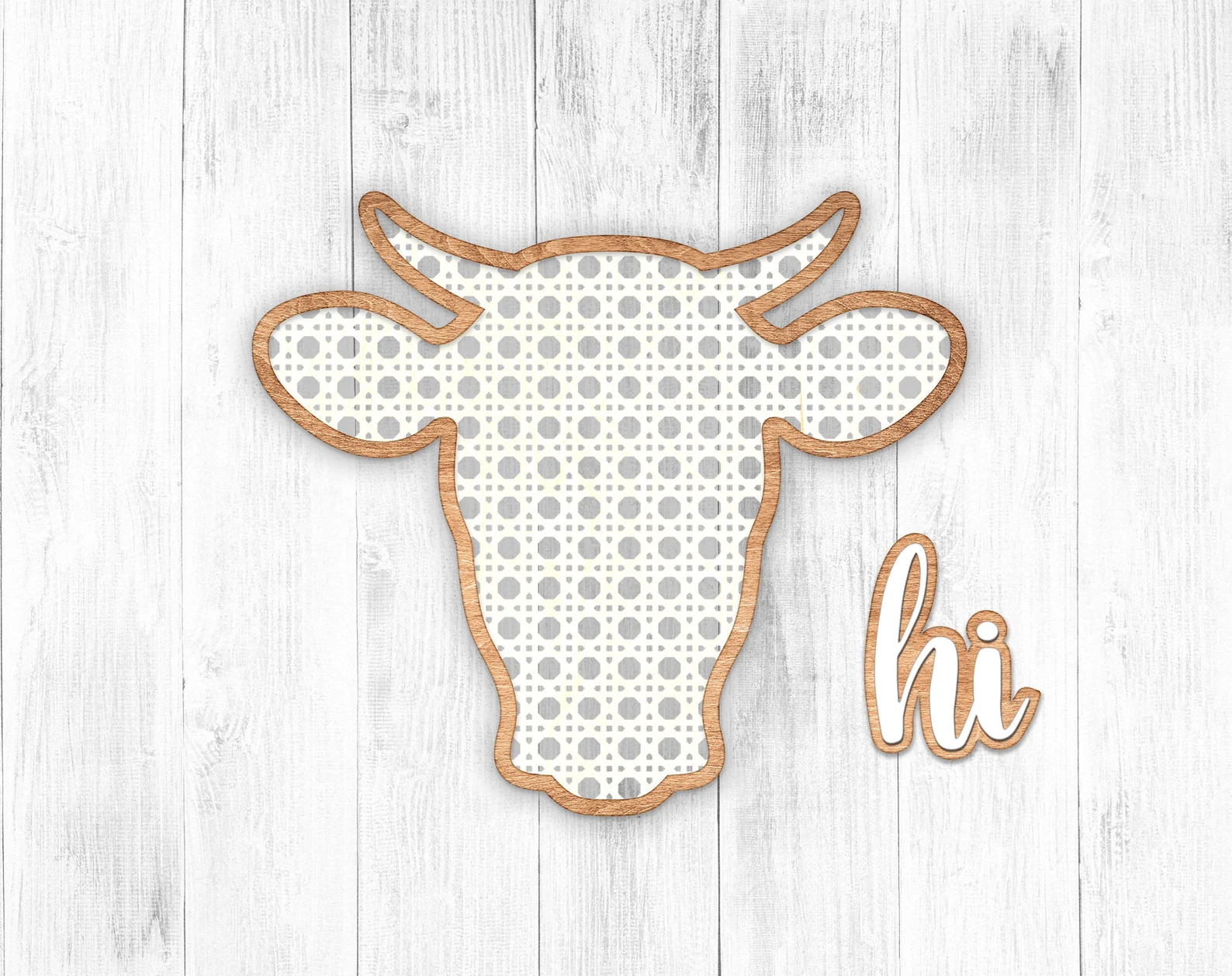 Grey wooden background with the outline cow in gold.