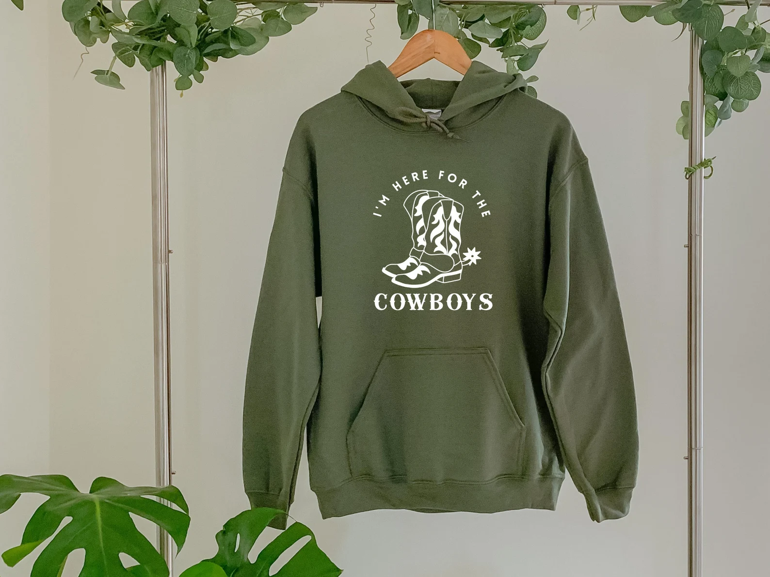 Olive warm sweater with a cowboys graphic.
