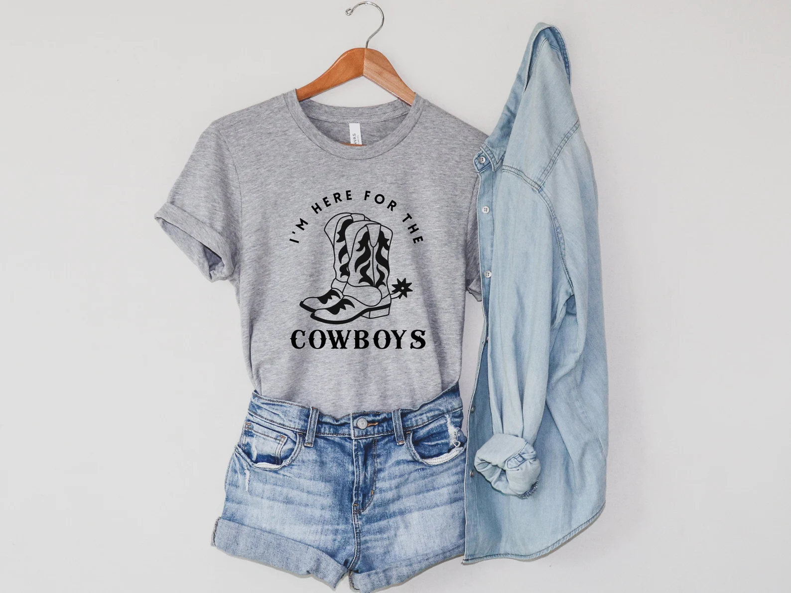 Grey t-shirt with cowboy boots.