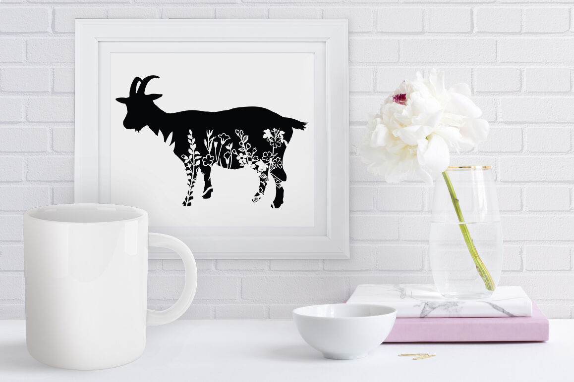 Picture of a goat on a wall next to a vase of flowers.