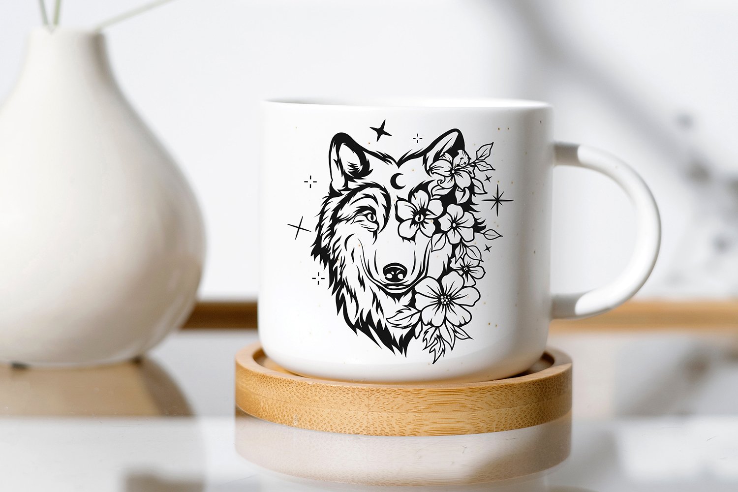 White coffee mug with a wolf design on it.