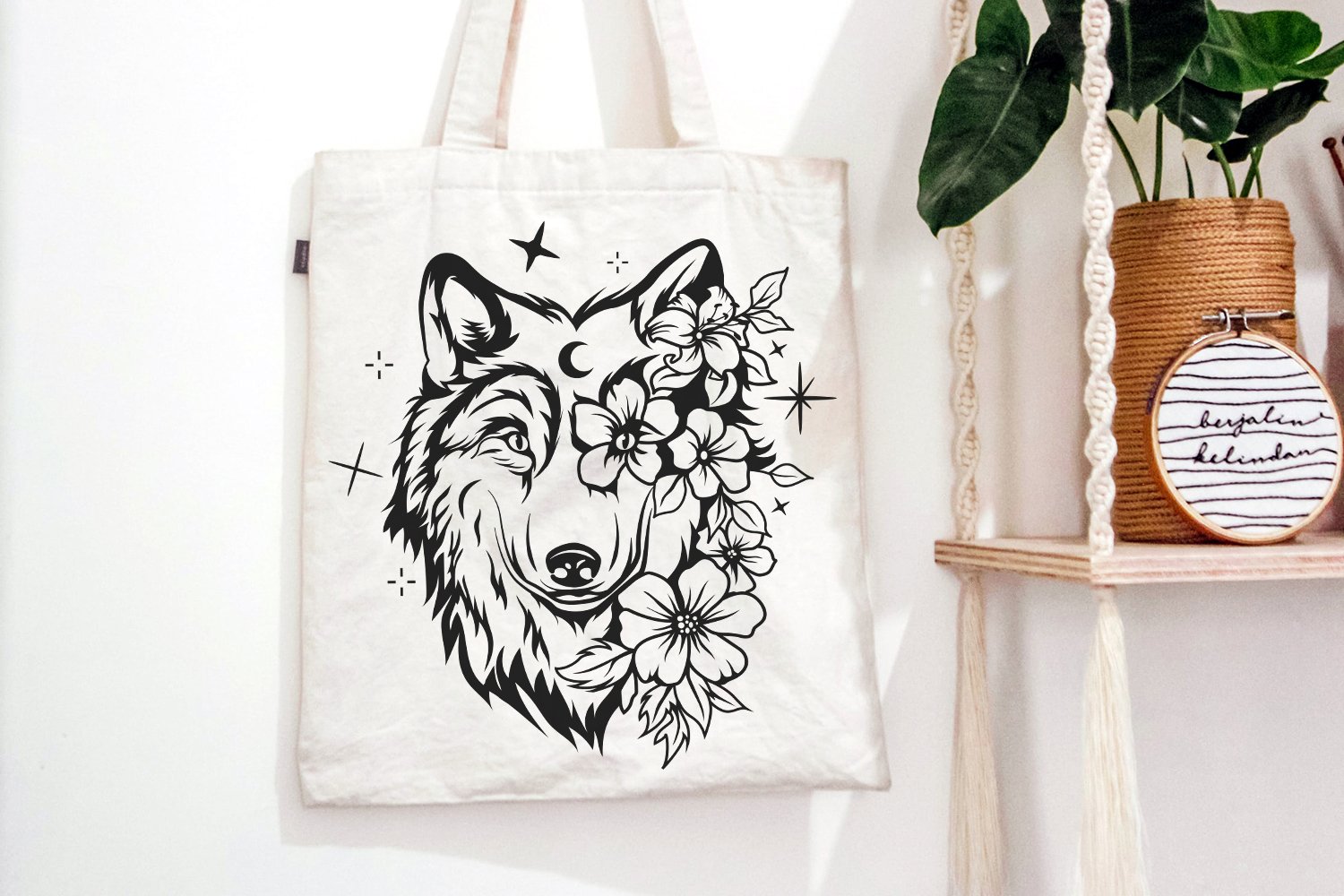 Tote bag with a wolf and flowers on it.
