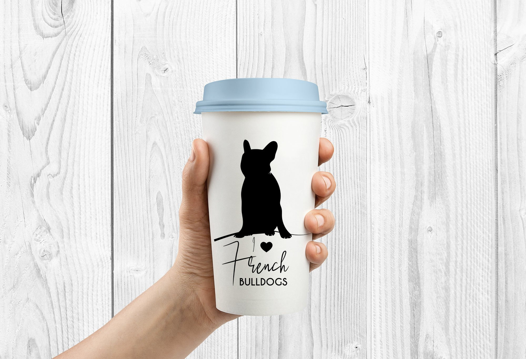 Person holding a coffee cup with a dog on it.