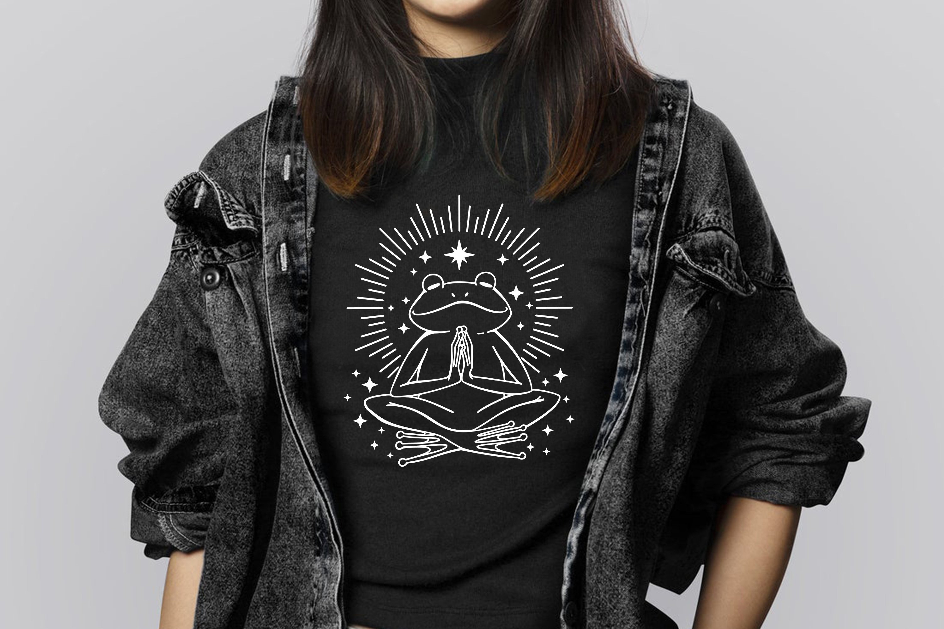 Woman wearing a black t - shirt with an image of a woman doing yoga.