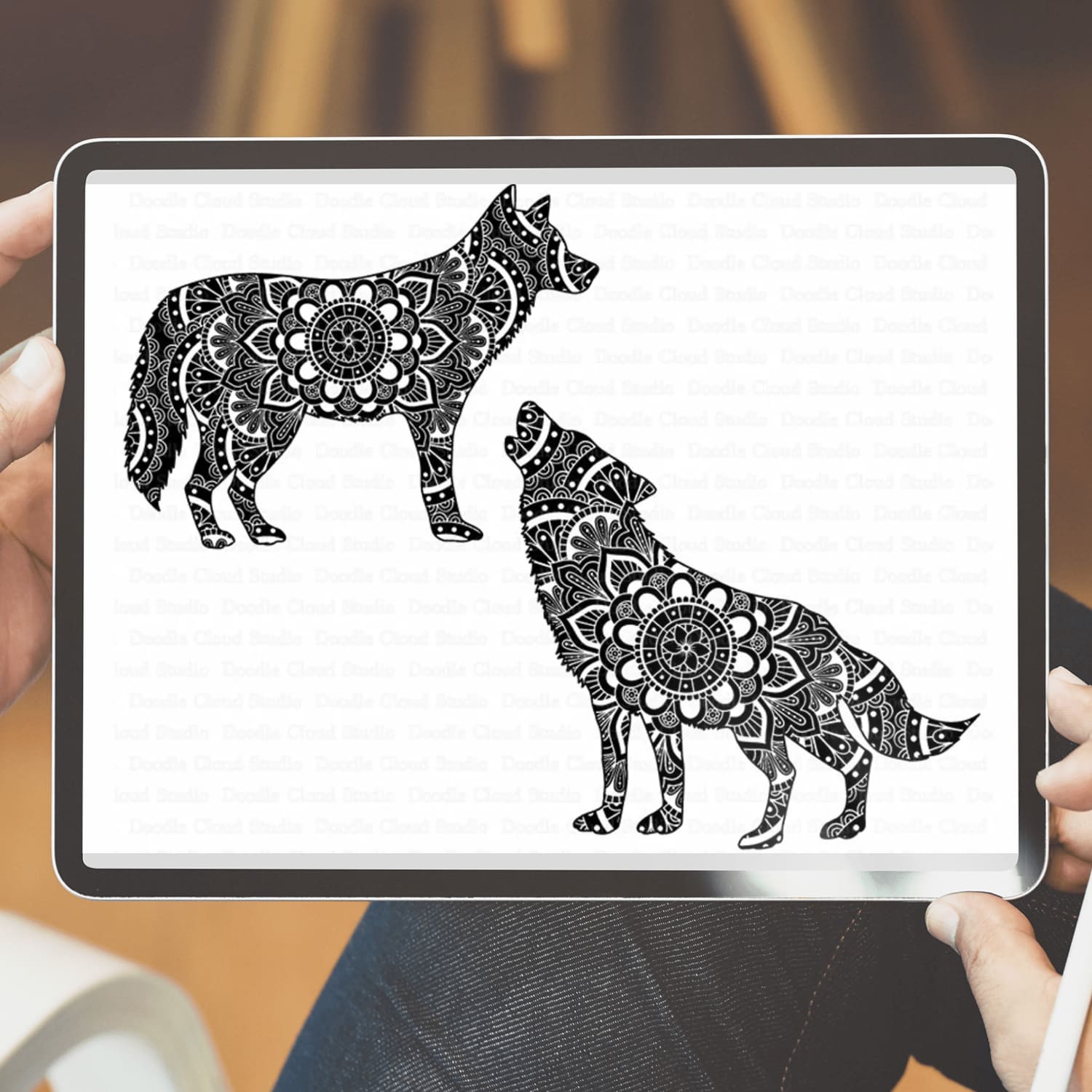 Person holding a tablet with a picture of two dogs on it.