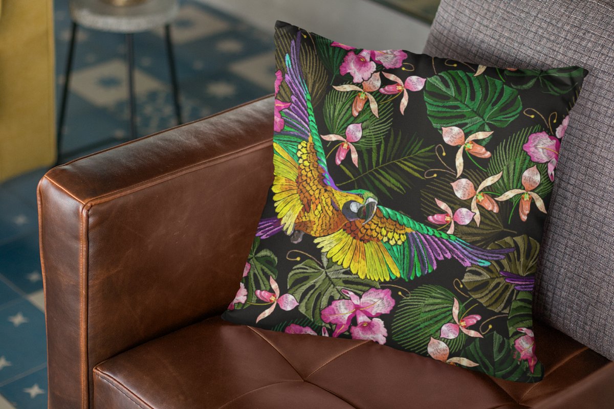Black pillow with parrots, orchids and palm leaves.