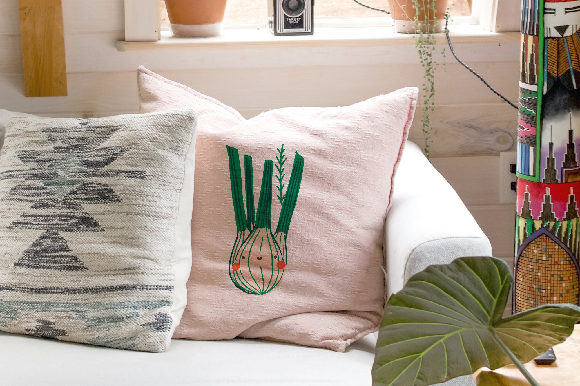 Creative onion graphic on a pastel pillow.