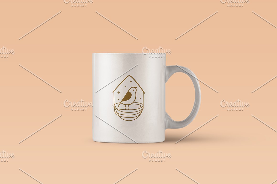Big white cup with gold bird logo.