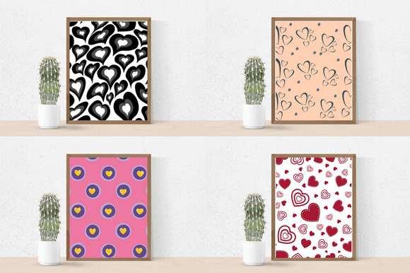 Cactus in pot and 4 pictures in brown frames - black hearts on a white background, black hearts on a peach background, yellow heart in purple and light blue circles on a pink background and red hearts on a white background.