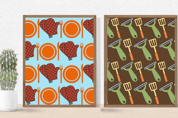 Cactus in a pot and 2 different pictures in brown frames - brown potholders and an orange plate with cutlery, a green vegetable peeler and a yellow spatula with an orange handle.