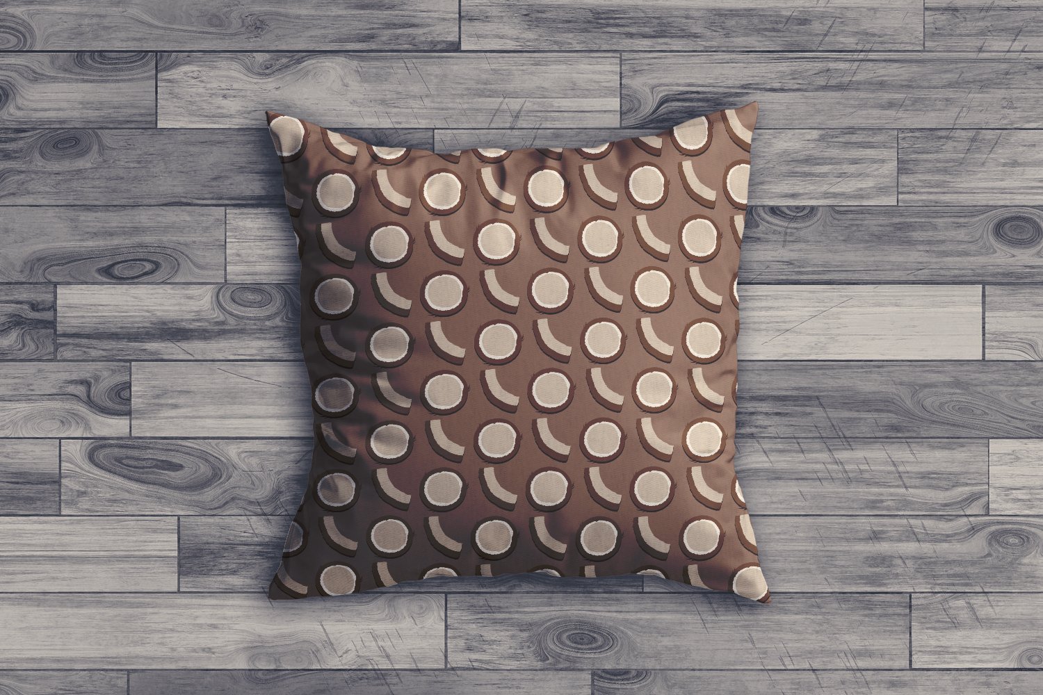 Small decorate pillow with brown coconut illustration.