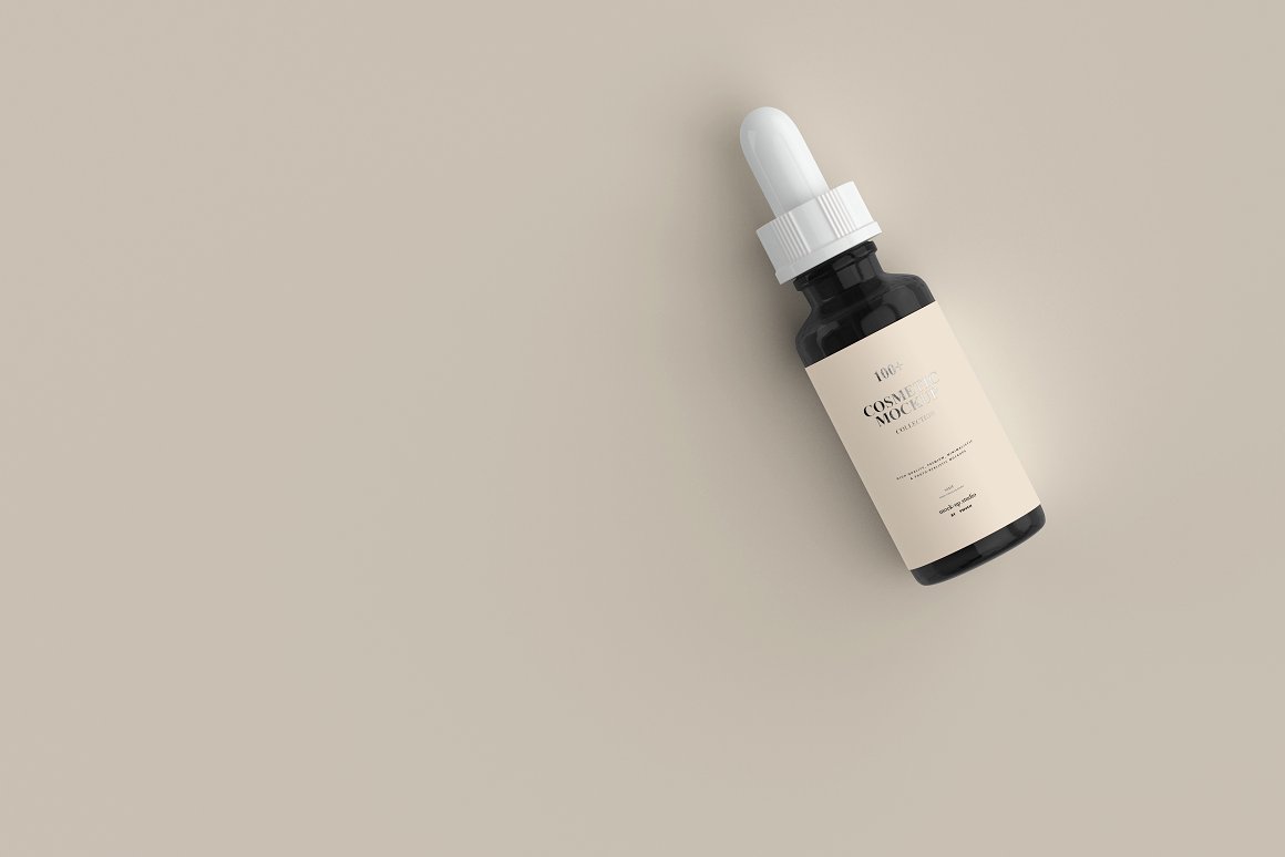 A dark glass serum with a beige label and a white pipette.