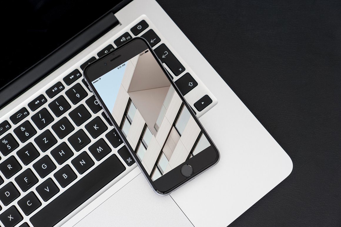 Black IPhone Mockup with an image on the MacBook.