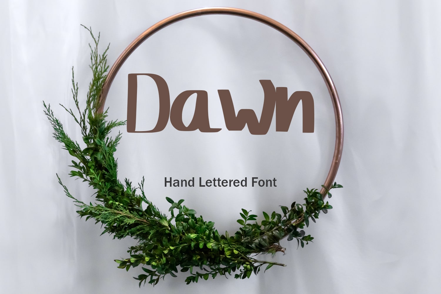 Bold brown font in a Christmas wreath.