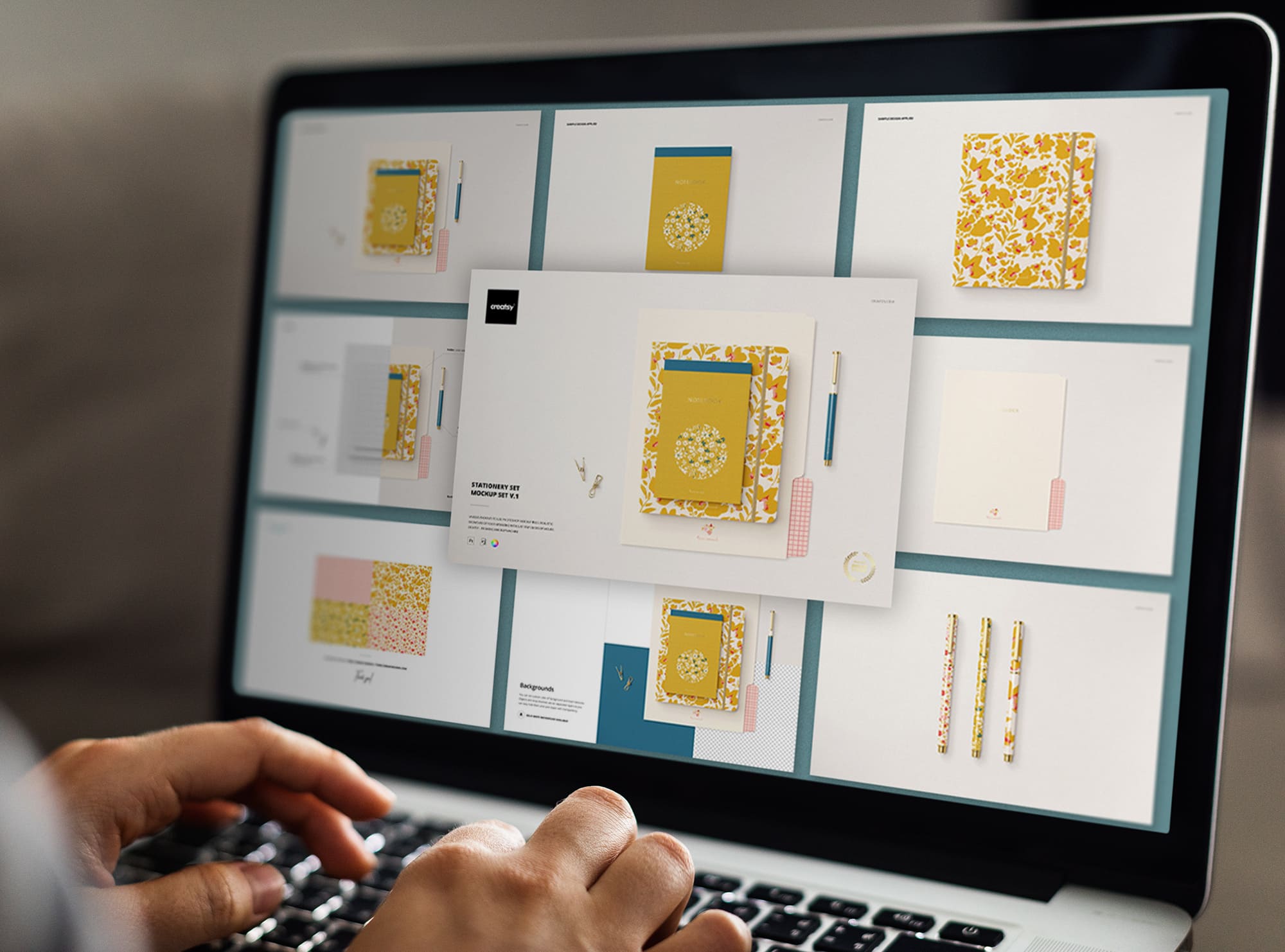 Laptop on screen with images of colorful stationery mockups.