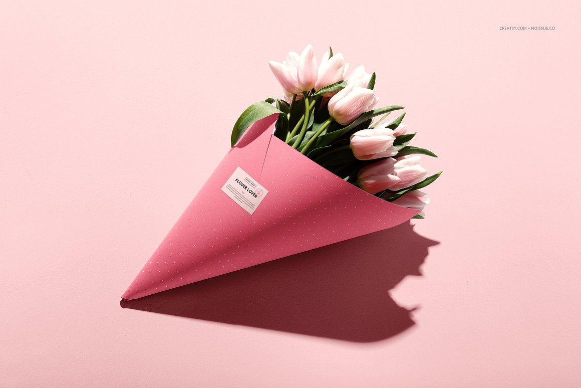 A bouquet of white and pink tulips in pink wrapping paper with a white label and the lettering "Flower Lover".