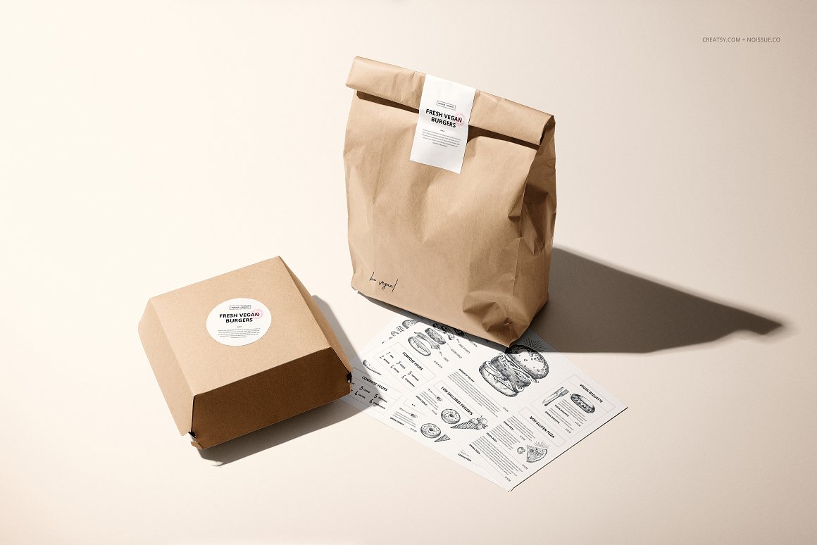 Kraft package and box with a white label and the inscription "Fresh Vegan Burgers".