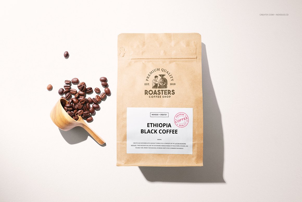 Kraft bag with coffee and a white label with the lettering "Ethiopia black coffee" and a spoon with coffee beans.