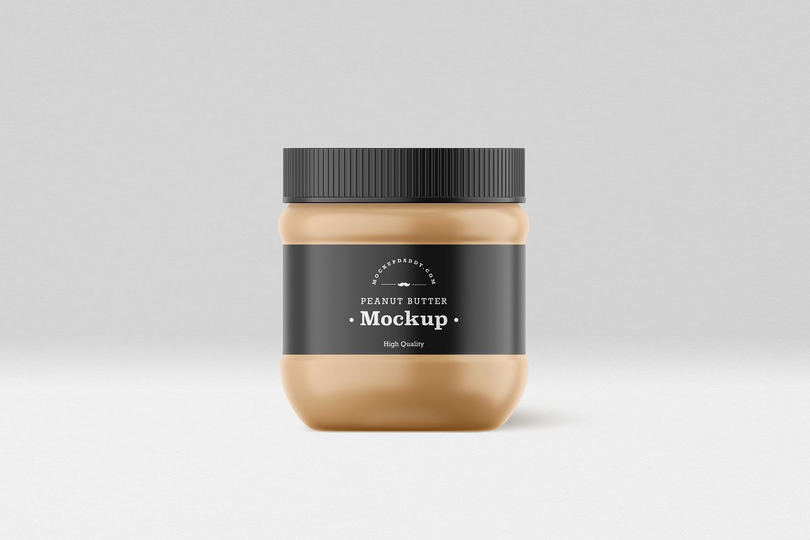 A Small Gold Glass Jar with a Peanut Butter, black label and black lid.