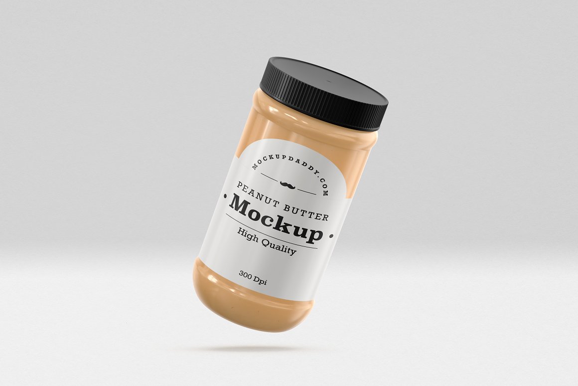 A Gold Glass Jar with a Peanut Butter, white label and black lid.