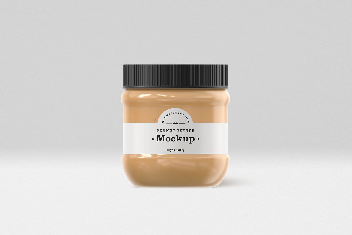 A Small Gold Glass Jar with a Peanut Butter, white label and black lid.