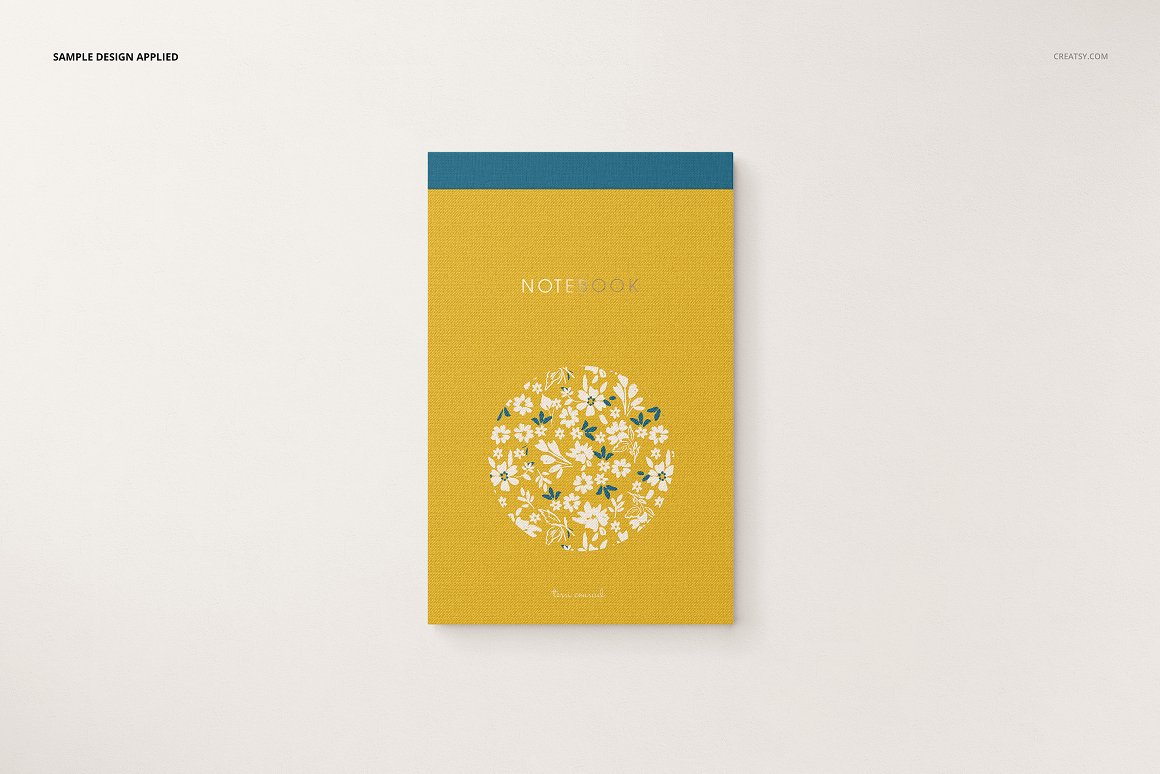 Irresistible image of a yellow notebook with white flowers.