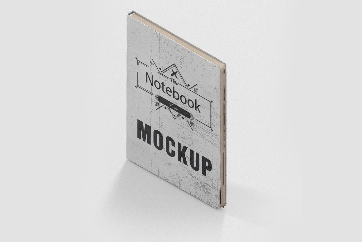 A gray vintage mockup notebook with black title "MOCKUP".
