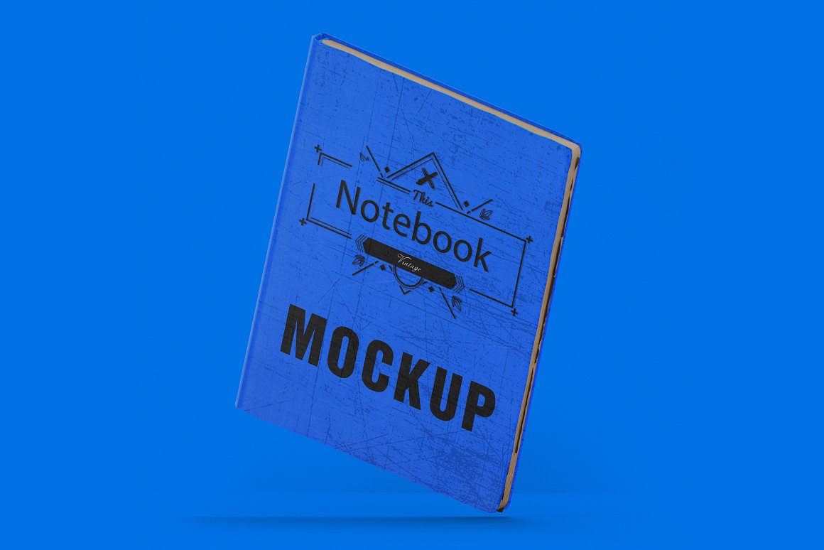 Black title "MOCKUP" on the mockup of a blue vintage notebook.