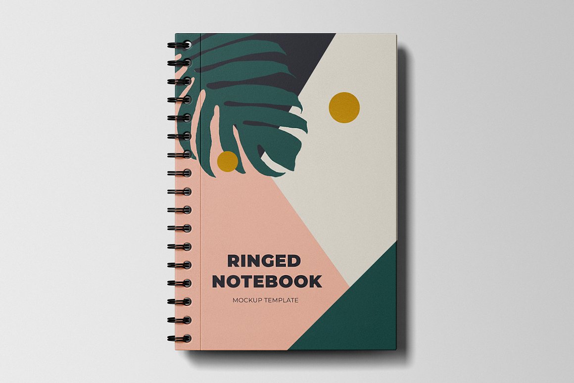 Dark blue, green, pink and white ringed notebook mockup with dark blue lettering "Ringer Notebook Mockup Template" and images of leaves, on a gray background.