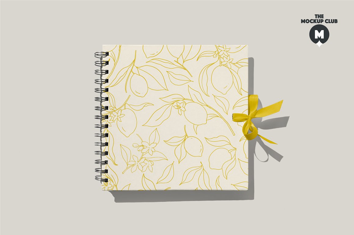 White notebook mockup with images lemons on a gray background.