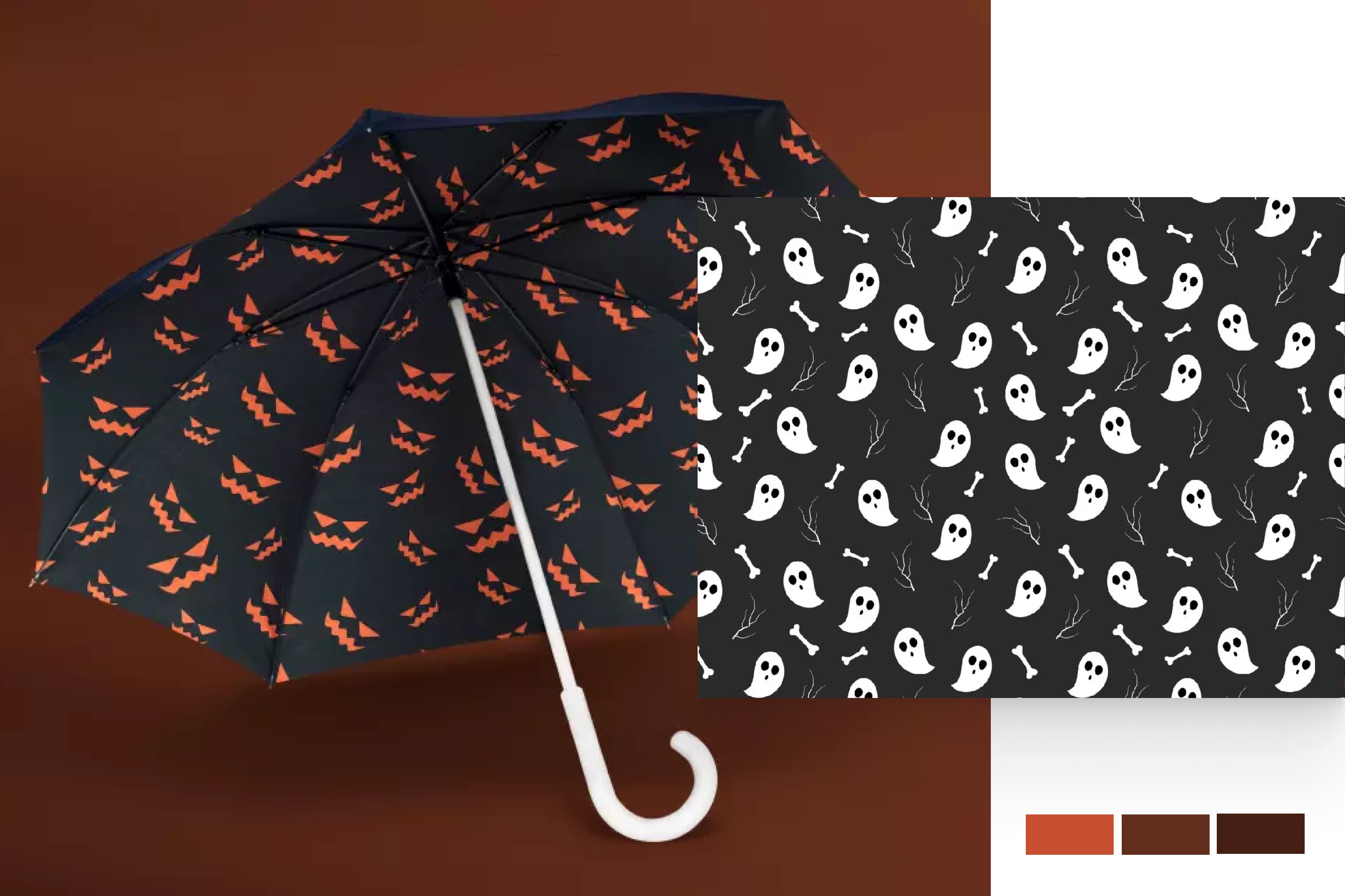 An open black umbrella with a white handle depicting ghosts and orange pumpkin eyes on it.