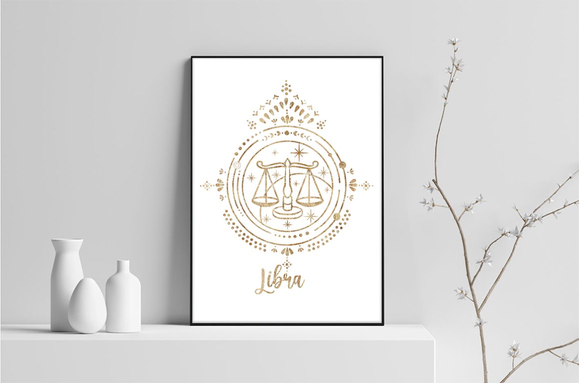 Painting of a golden zodiac sign - Libra on a white background in black frame, on a gray background.
