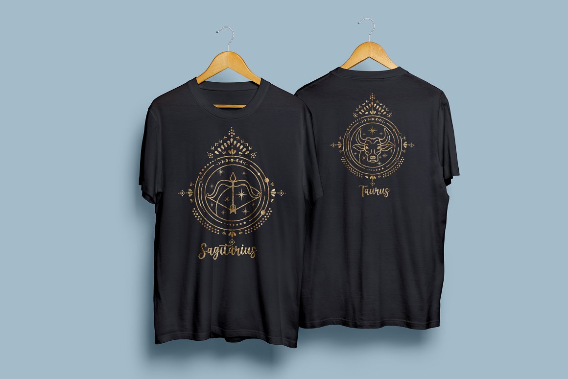 2 black t-shirt with a golden zodiac signs on a wooden hanger on a blue background.