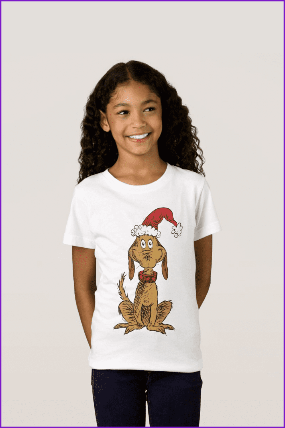 Girl in the t-shirt with a dog in a Santa hat and a red collar.