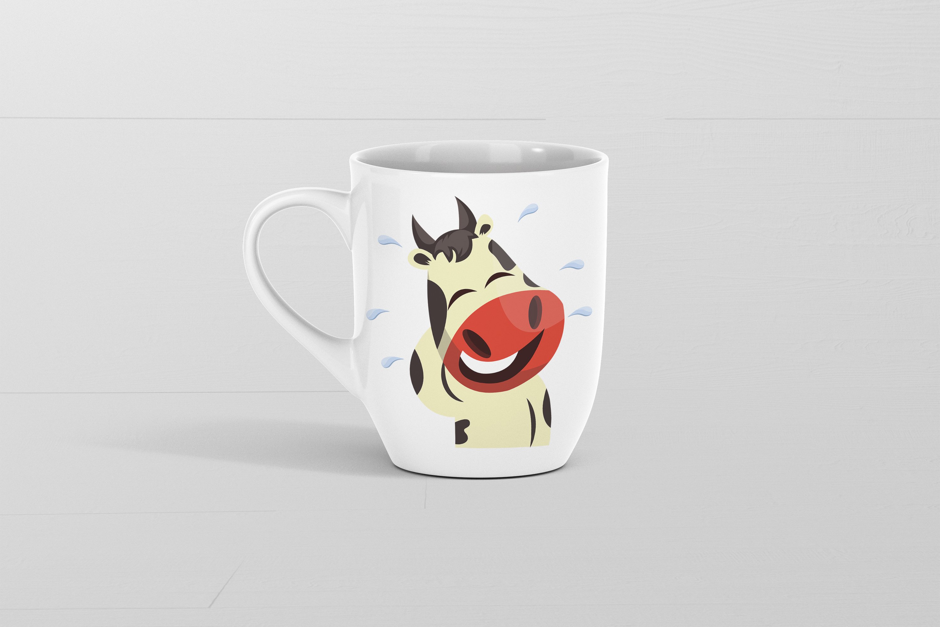 Image of a white cup with a funny cow emoticon.