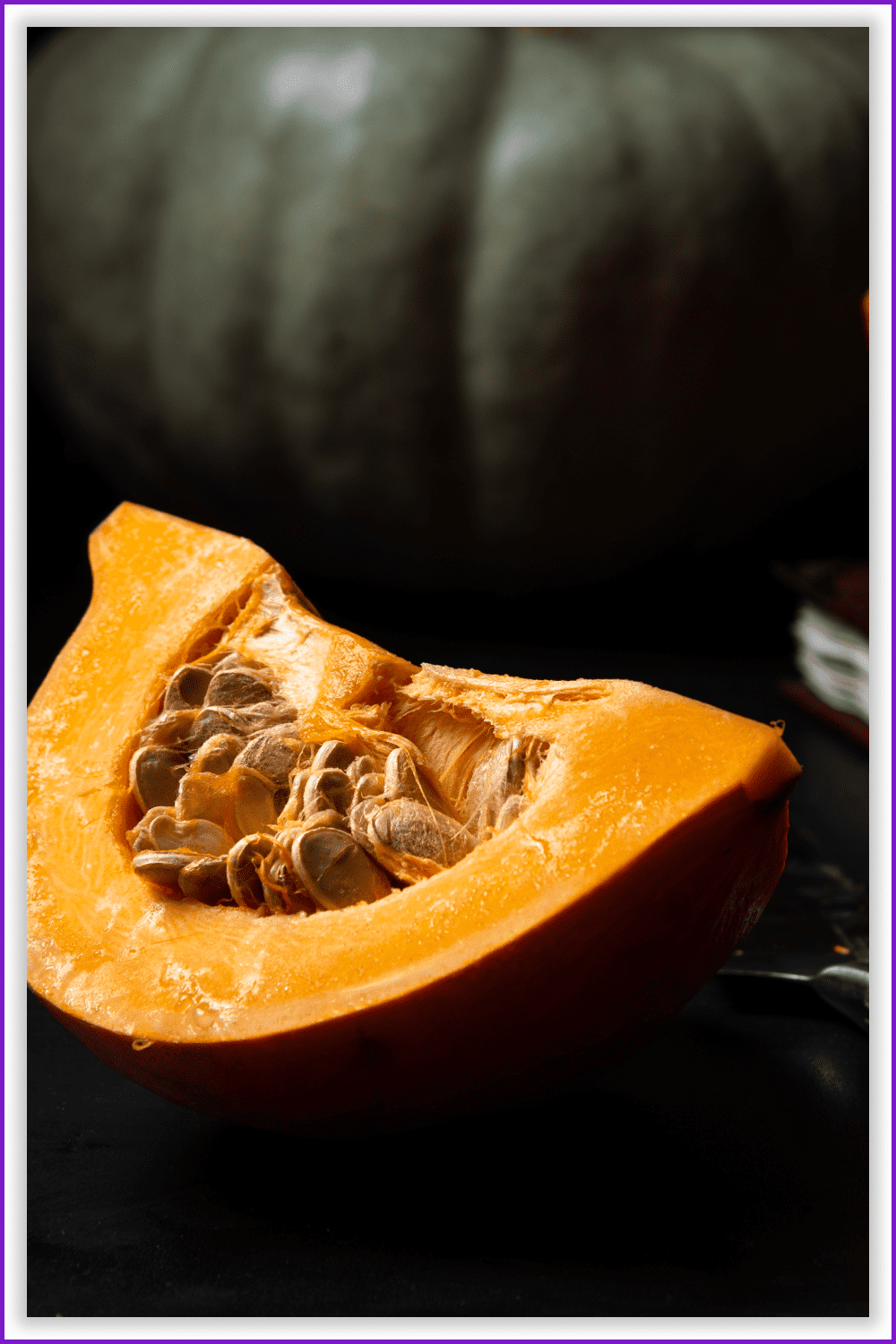 Detailed photo of a piece of pumpkin with seeds inside.