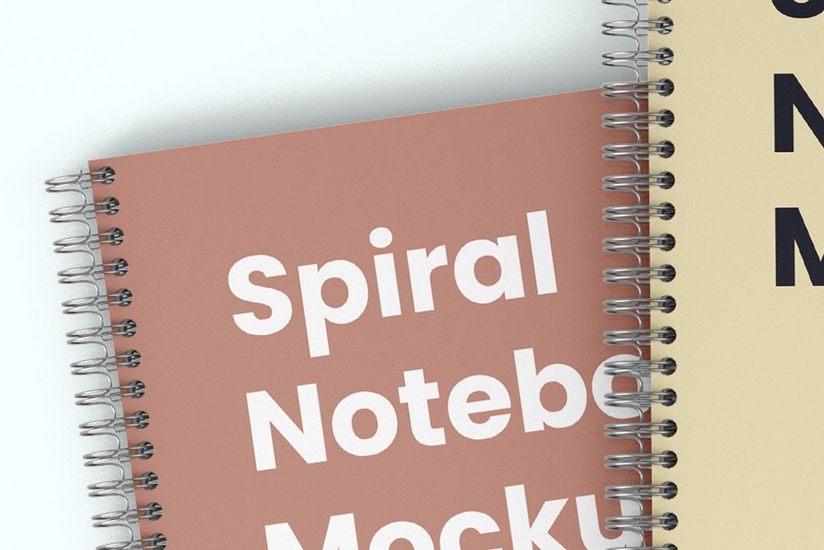 Mockup details of a beige notebook with a silver spiral and a pink notebook with a silver spiral on a white background.