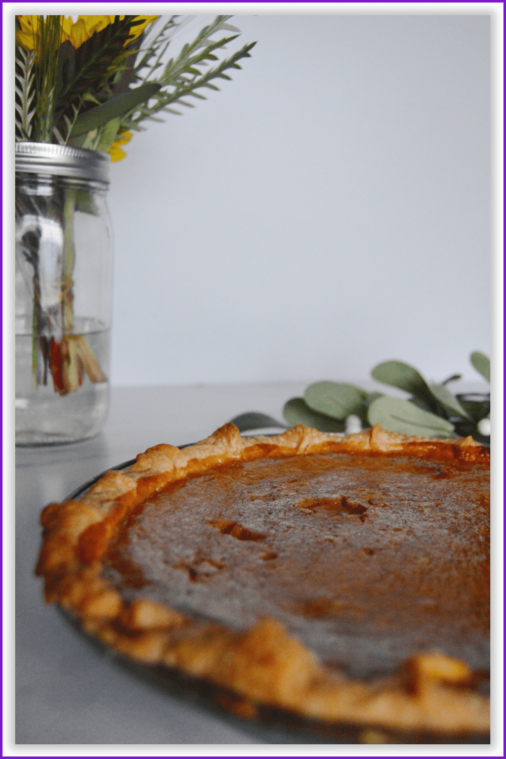 A vertical closeup photo of a pumpkin pie in minimalist aesthetics..