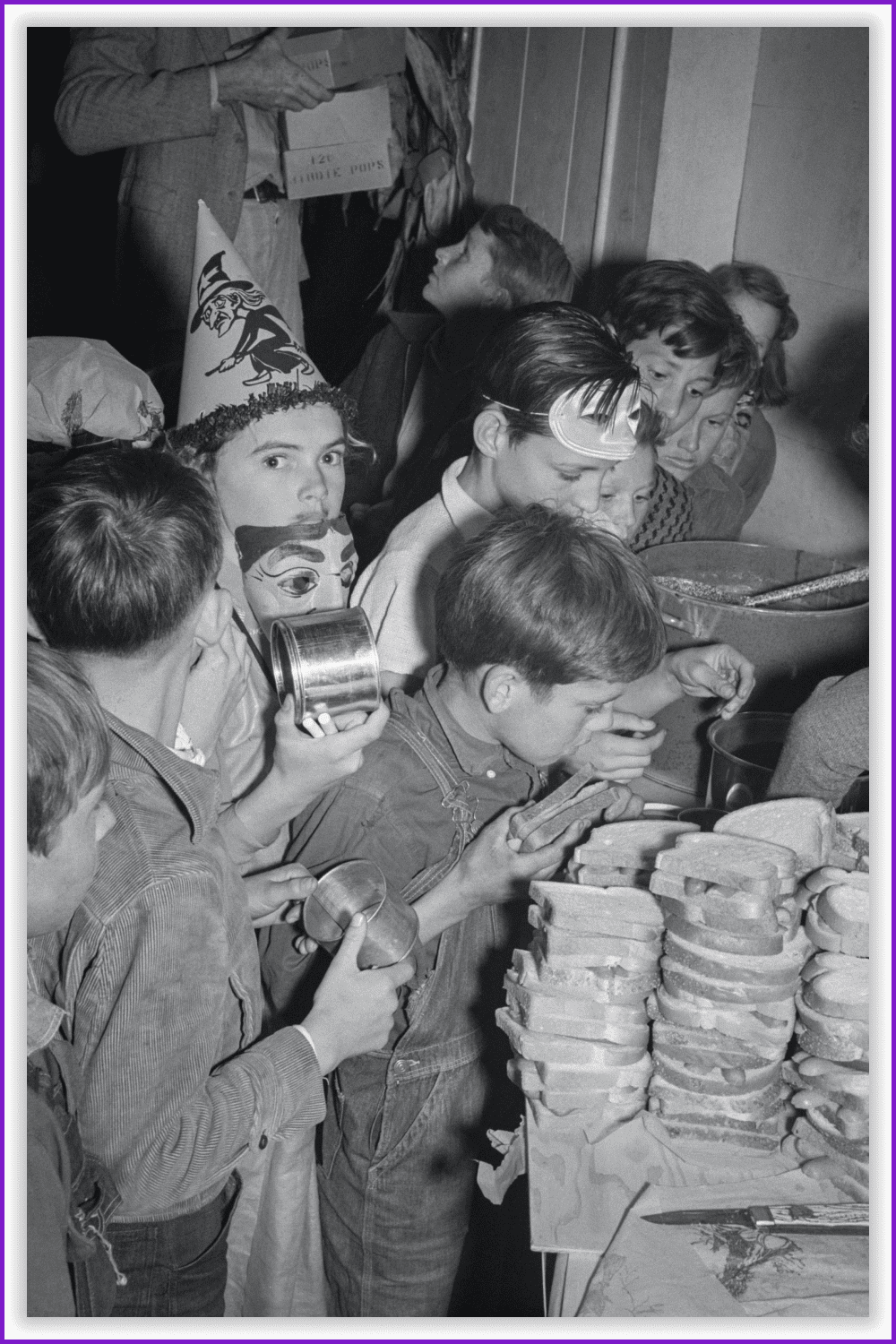 The children crowd and push to reach the refreshments at the halloween party in the shafter migrant camp.