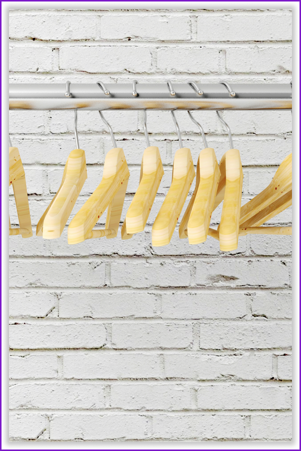 Wooden hangers against a white brick wall.