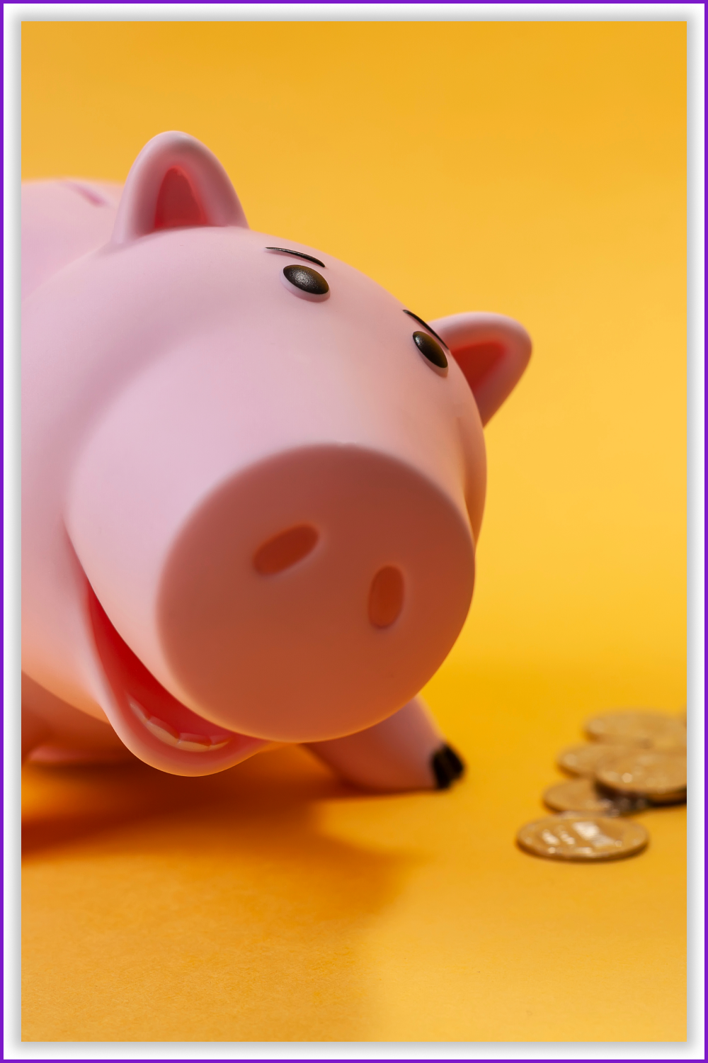 The smiling piggy bank with coins on the yellow background.