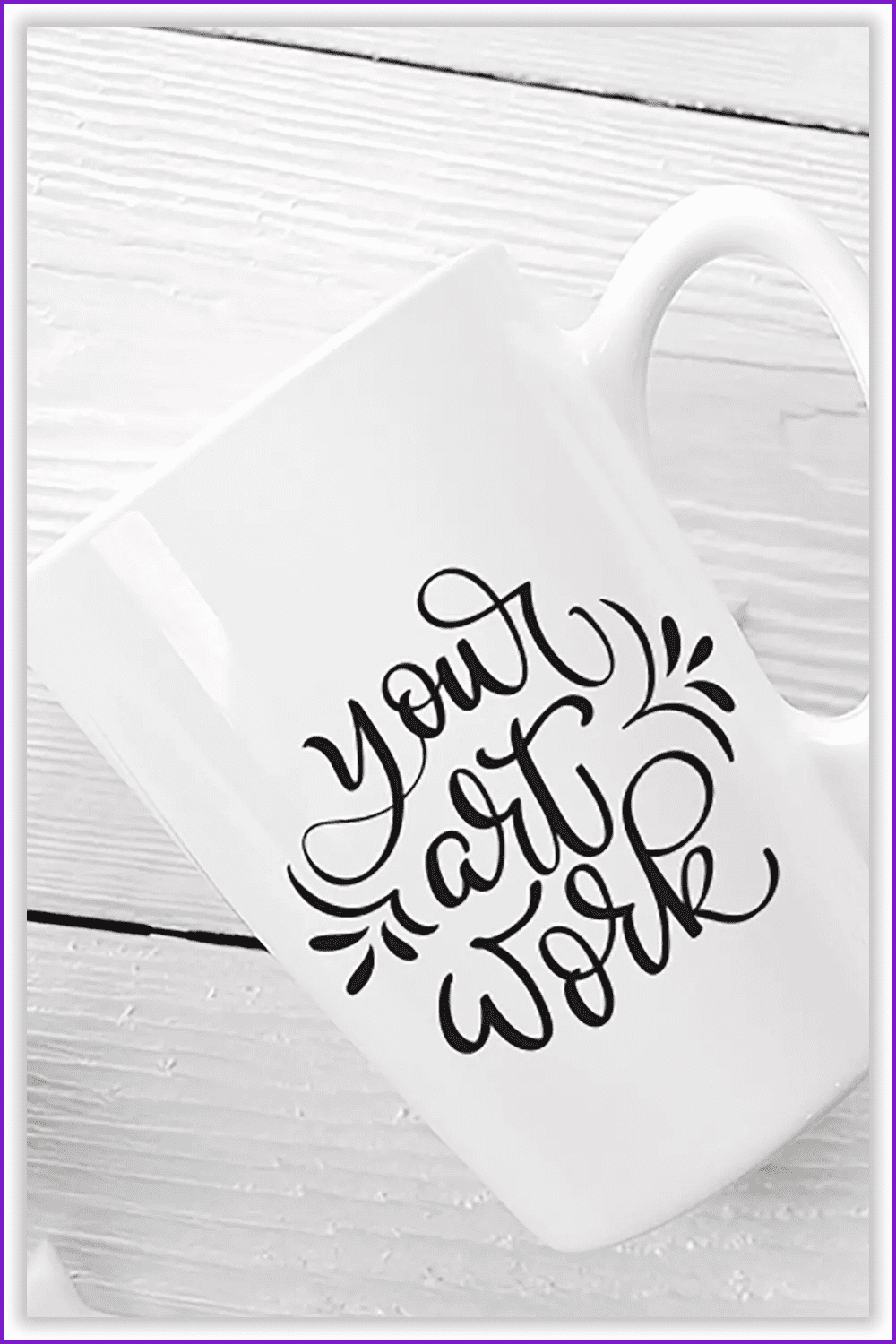 Photo of a white mug with black text on a white table.