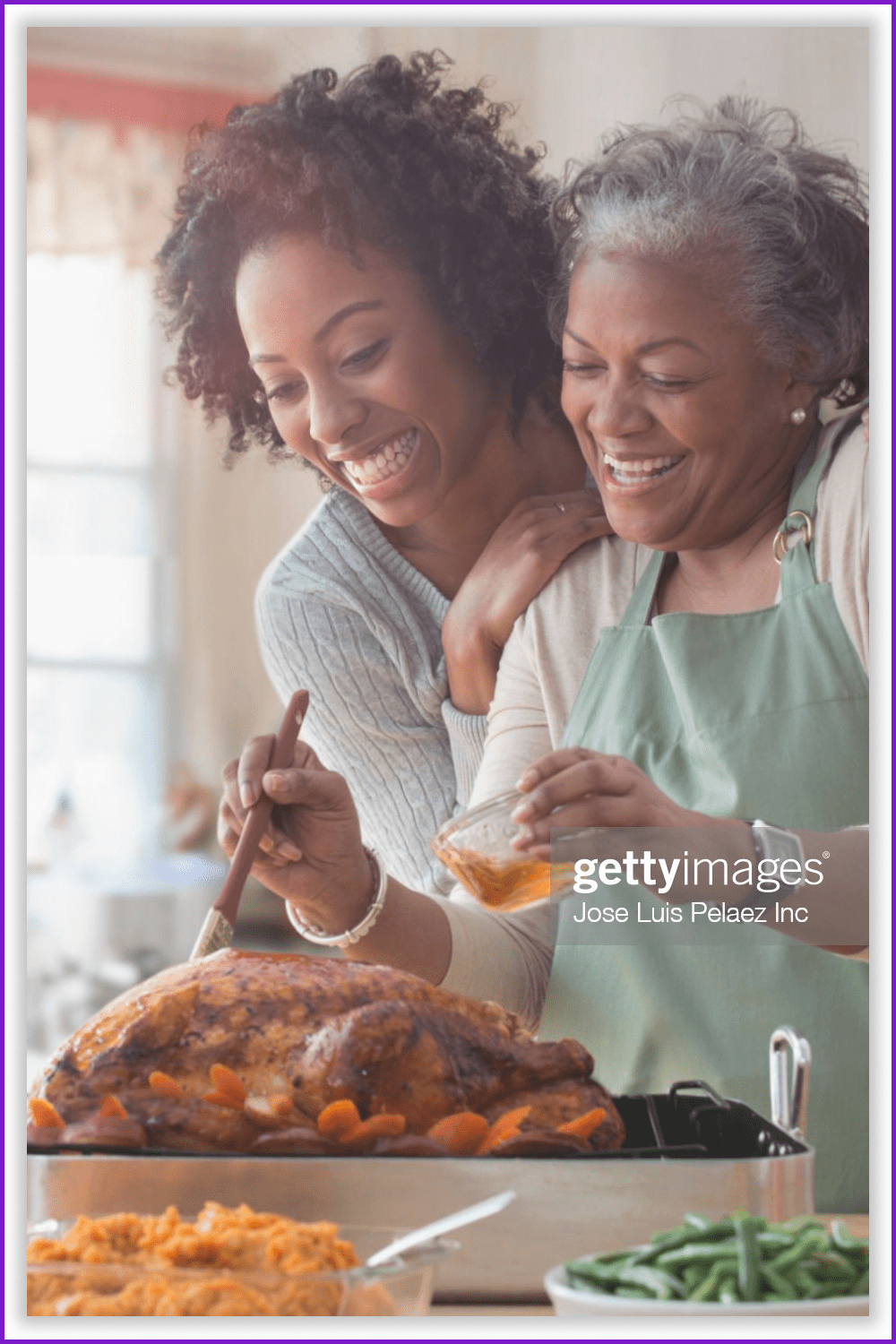 A photo of a mother and daughter preparing a turkey together in the kitchen.