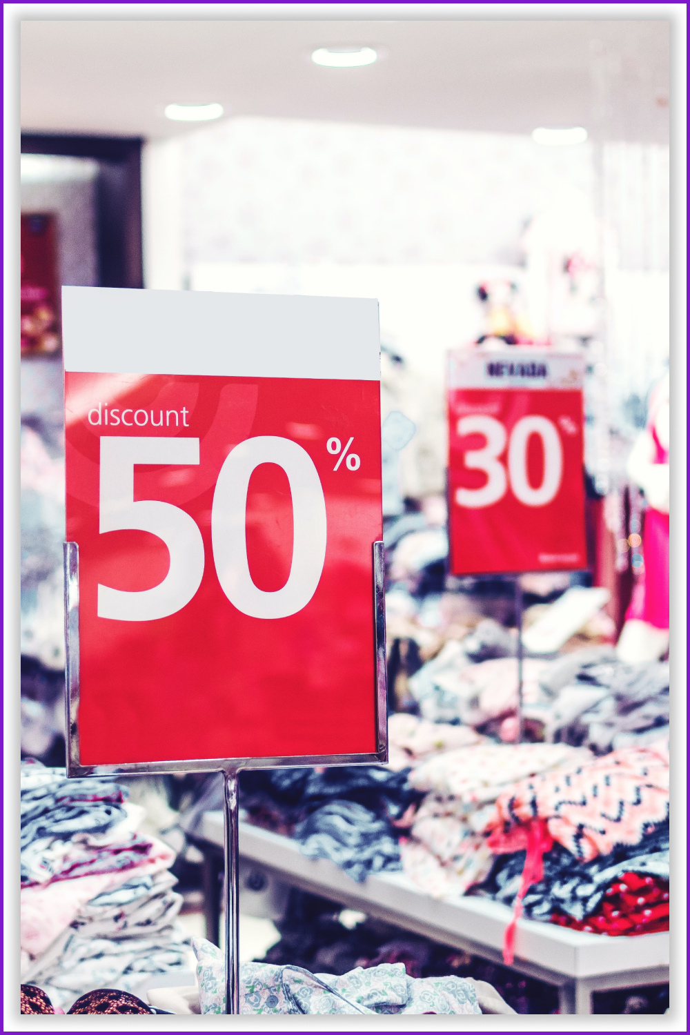 Two large red signs with the size of the discount on the background of the shelves with clothes.