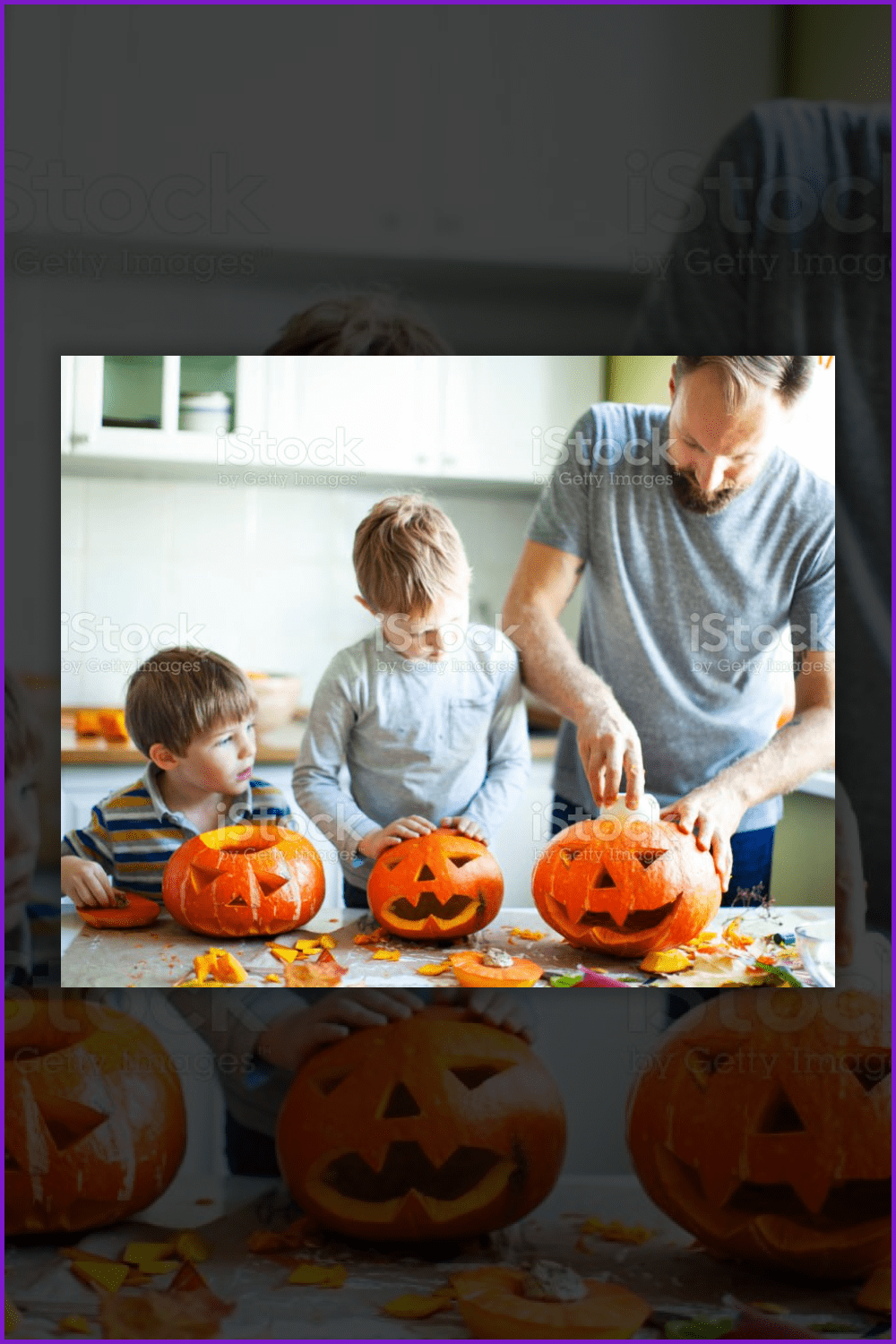 Father showing sons how to carve pumpkins.