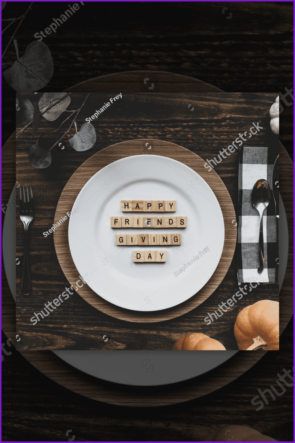 Photo of the table with a “Happy Friendsgiving Day” message spelled out with wood block letters.