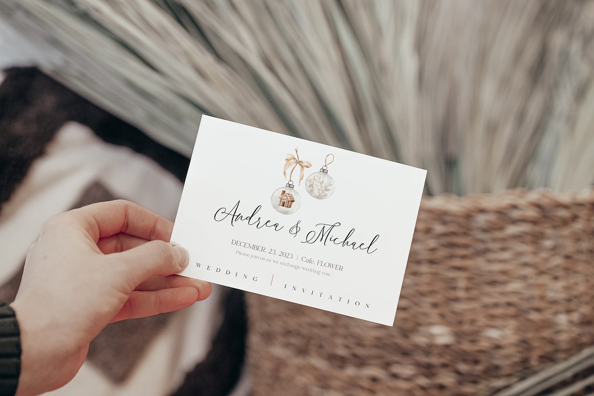 A white wedding invitation with lettering "Andrea & Michael".