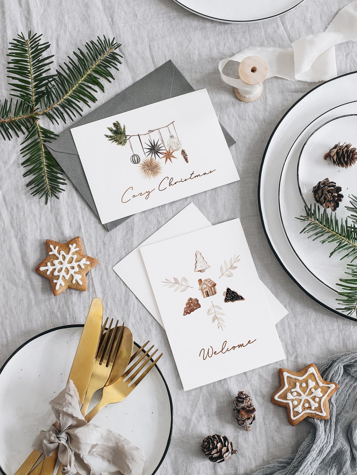 3 white greeting card with "Cozy Christmas" and "Welcome" lettering and gray envelope.