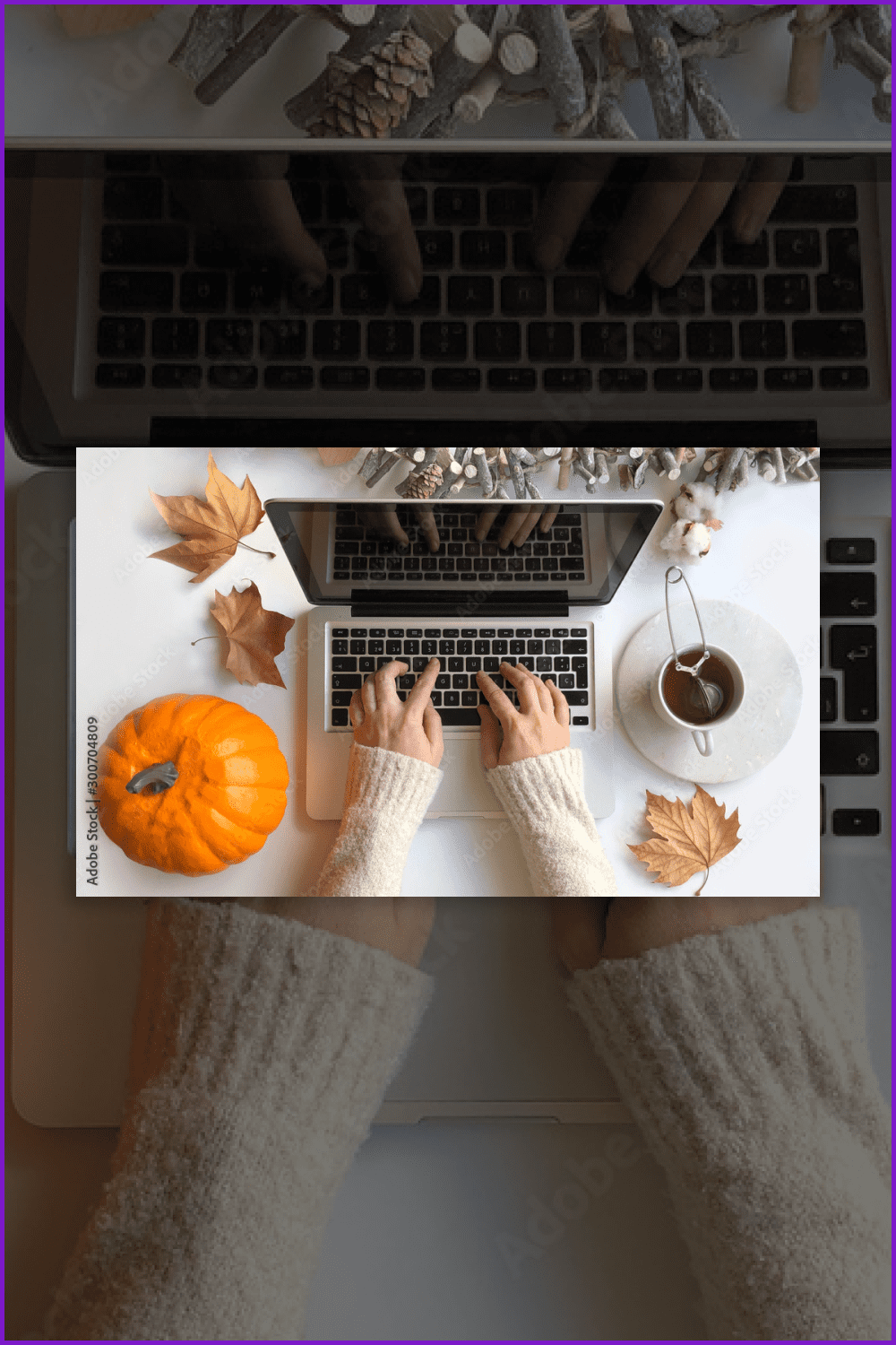 A woman is typing on a laptop surrounded by maple leaves, a pumpkin, a teacup, and a tree branch decor.